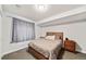 Basement bedroom featuring neutral tones, carpet flooring, and a queen-size bed at 22227 E Hinsdale Ave, Aurora, CO 80016
