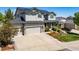 Charming gray two-story home featuring a well-maintained front yard with a three car garage at 22227 E Hinsdale Ave, Aurora, CO 80016