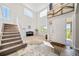 Bright, spacious foyer with soaring ceilings, elegant tile flooring, and a grand staircase at 22227 E Hinsdale Ave, Aurora, CO 80016