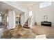 Inviting foyer featuring high ceilings, stylish tile accents, and a staircase leading to upper level at 22227 E Hinsdale Ave, Aurora, CO 80016