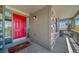Charming front porch with stone accents, a bright red door, and a cozy spot to relax at 22227 E Hinsdale Ave, Aurora, CO 80016