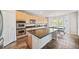 Gourmet kitchen featuring stainless appliances, granite counters, island seating, and eat in breakfast nook at 22227 E Hinsdale Ave, Aurora, CO 80016