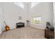 Bright living room with high ceilings, natural light, piano, and cozy carpet flooring at 22227 E Hinsdale Ave, Aurora, CO 80016