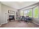 Office featuring fireplace, built-in shelving, and large bay window at 22227 E Hinsdale Ave, Aurora, CO 80016