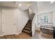 Basement staircase landing featuring a bench dining set and access to the backyard at 22227 E Hinsdale Ave, Aurora, CO 80016