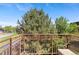 Balcony view showcasing lush trees and an outdoor sitting area at 7828 W 54Th Ave, Arvada, CO 80002