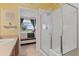 Bathroom with light yellow walls and access to the bedroom at 7828 W 54Th Ave, Arvada, CO 80002