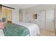 Bedroom featuring neutral colors, barn door to the bathroom, and closet at 7828 W 54Th Ave, Arvada, CO 80002