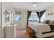 Bright bedroom with a large window, bench seat, and neutral colored carpet at 7828 W 54Th Ave, Arvada, CO 80002