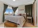 Bright bedroom featuring a large window with views, and barn door to the bathroom at 7828 W 54Th Ave, Arvada, CO 80002