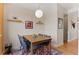 Warm and inviting dining room with modern light fixture, hardwood floors and contemporary decor at 7828 W 54Th Ave, Arvada, CO 80002