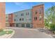 Row of colorful townhomes in Arvada, Colorado, each with a garage at 7828 W 54Th Ave, Arvada, CO 80002