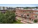 Brick condo building featuring private balconies, lush greenery, and mountain views at 7828 W 54Th Ave, Arvada, CO 80002
