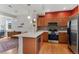 Inviting kitchen showcasing stainless steel appliances, ample counter space, and hardwood floors at 7828 W 54Th Ave, Arvada, CO 80002