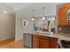 Bright and modern kitchen featuring stainless steel appliances, hardwood floors and an open concept living space at 7828 W 54Th Ave, Arvada, CO 80002