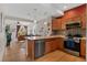 Stylishly designed kitchen featuring stainless steel appliances, and hardwood floors, open to the living room at 7828 W 54Th Ave, Arvada, CO 80002