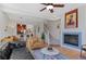 The open concept living room features a fireplace, hardwood floors, and easy access to the kitchen at 7828 W 54Th Ave, Arvada, CO 80002