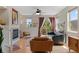 Open-concept living area showcasing hardwood floors, a fireplace, and stylish furnishings at 7828 W 54Th Ave, Arvada, CO 80002