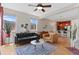 Cozy open concept living room with hardwood floors, large windows for natural light, and a view of the kitchen at 7828 W 54Th Ave, Arvada, CO 80002