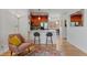 An inviting living space featuring a breakfast bar to the kitchen with an open concept dining space at 7828 W 54Th Ave, Arvada, CO 80002