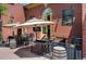 Outdoor patio with covered seating, wrought iron railings, wine barrels, and patio television at 7828 W 54Th Ave, Arvada, CO 80002