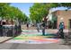 Street view of people enjoying the vibrant, colorful pavement, a popular attraction at 7828 W 54Th Ave, Arvada, CO 80002