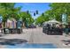 Street view of outdoor dining area along a city street in Arvada with mature shade trees at 7828 W 54Th Ave, Arvada, CO 80002