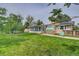 Picturesque backyard featuring a sunroom, greenhouse, and lush green grass at 8300 W 67Th Ave, Arvada, CO 80004