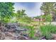 Scenic backyard view showcasing water feature surrounded by rocks and plants at 8300 W 67Th Ave, Arvada, CO 80004