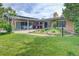 Spacious backyard featuring a lush lawn, outdoor lighting, and a covered patio with furniture at 8300 W 67Th Ave, Arvada, CO 80004