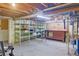 Unfinished basement with shelving and workbench at 8300 W 67Th Ave, Arvada, CO 80004