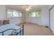 Bedroom with two large windows providing natural light, carpeted floors and access to storage space at 8300 W 67Th Ave, Arvada, CO 80004