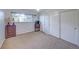 Bedroom featuring neutral carpet, a window with natural light and a closet with sliding doors for storage at 8300 W 67Th Ave, Arvada, CO 80004
