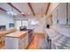 Bright kitchen features an island with gas range, patterned backsplash, and hardwood floors at 8300 W 67Th Ave, Arvada, CO 80004