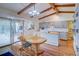 Sunlit kitchen with an island, wooden floors, and access to the back patio at 8300 W 67Th Ave, Arvada, CO 80004