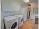 Convenient laundry room includes washer, dryer, cabinets, and a refrigerator at 8300 W 67Th Ave, Arvada, CO 80004
