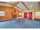 Rustic living room with a brick fireplace, vaulted ceilings, and exposed wood beams, creating a cozy ambiance at 8300 W 67Th Ave, Arvada, CO 80004