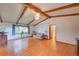 Inviting living room featuring hardwood floors, vaulted ceilings, and a decorative light fixture at 8300 W 67Th Ave, Arvada, CO 80004
