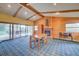 Rustic living room featuring a brick fireplace, vaulted ceilings, and exposed wood beams, creating a warm atmosphere at 8300 W 67Th Ave, Arvada, CO 80004