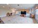 Spacious living room with large windows, natural light, and neutral carpeting throughout the open area at 8300 W 67Th Ave, Arvada, CO 80004