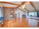 Bright living room with a stone fireplace, hardwood floors, and vaulted ceilings, creating a warm ambiance at 8300 W 67Th Ave, Arvada, CO 80004