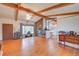 Living room with hardwood floors, a stone fireplace, and an open layout into the dining area at 8300 W 67Th Ave, Arvada, CO 80004