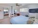Main bedroom featuring a fireplace, ceiling fan, and two closets as well as views into other rooms at 8300 W 67Th Ave, Arvada, CO 80004