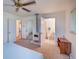 Main bedroom featuring a fireplace, ceiling fan, views into the bathroom and an additional bedroom at 8300 W 67Th Ave, Arvada, CO 80004