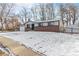 Front view of ranch home with snow covered yard at 4198 E 117Th Ave, Thornton, CO 80233