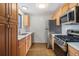 Modern kitchen with stainless steel appliances and wood cabinets at 4198 E 117Th Ave, Thornton, CO 80233