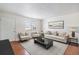 Living room with hardwood floors, comfy seating and large window at 4198 E 117Th Ave, Thornton, CO 80233