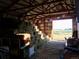 Interior of barn with hay bales and farm equipment at 3428 W County Road 4, Berthoud, CO 80513