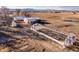 Aerial view of barns, sheds, and a greenhouse, complete with farm infrastructure at 3428 W County Road 4, Berthoud, CO 80513