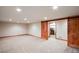 Basement with neutral carpeting, wood trim, recessed lighting, and barn door to laundry at 3428 W County Road 4, Berthoud, CO 80513